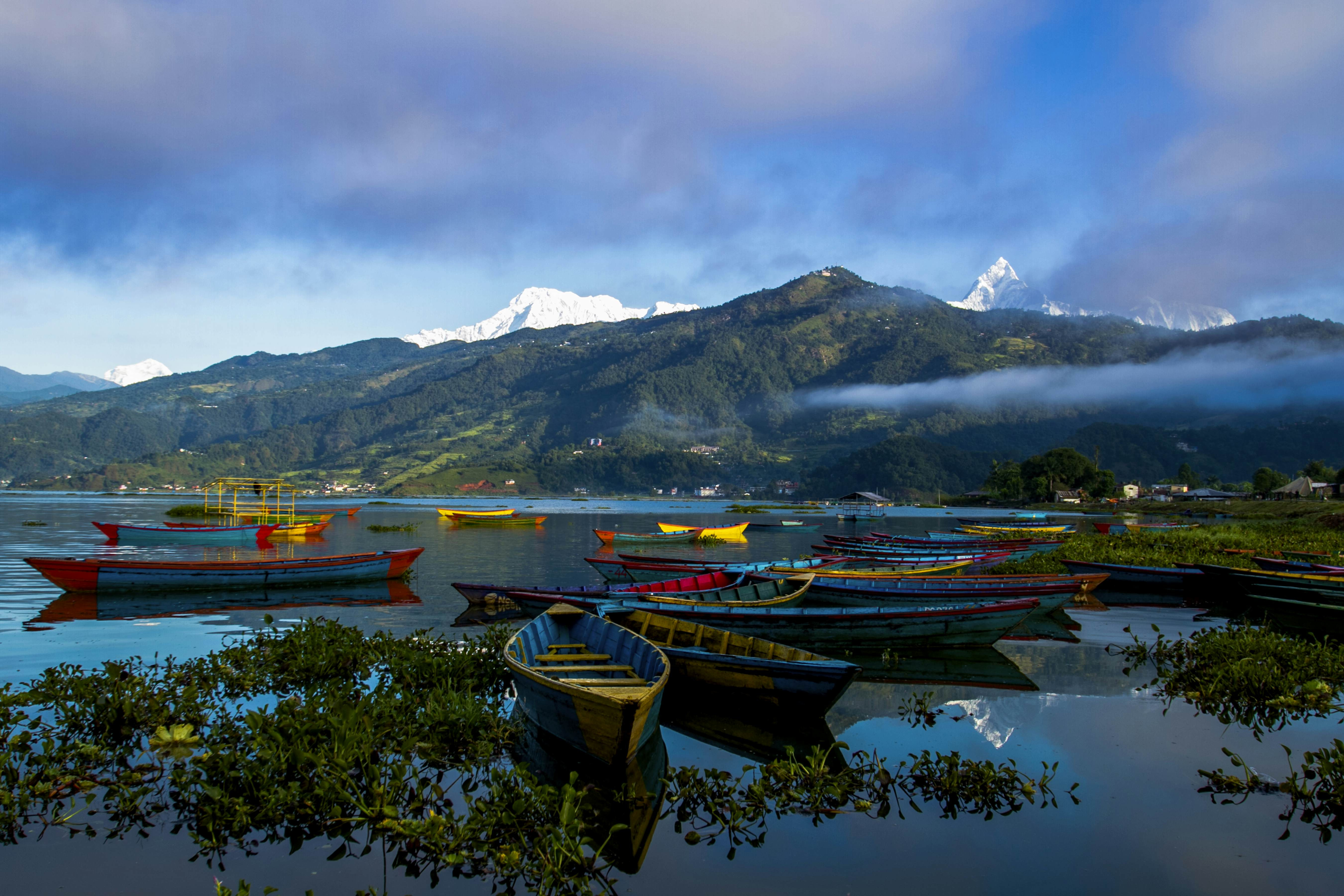 Wooden boats on the serene Phewa Lake in Pokhara, Nepal