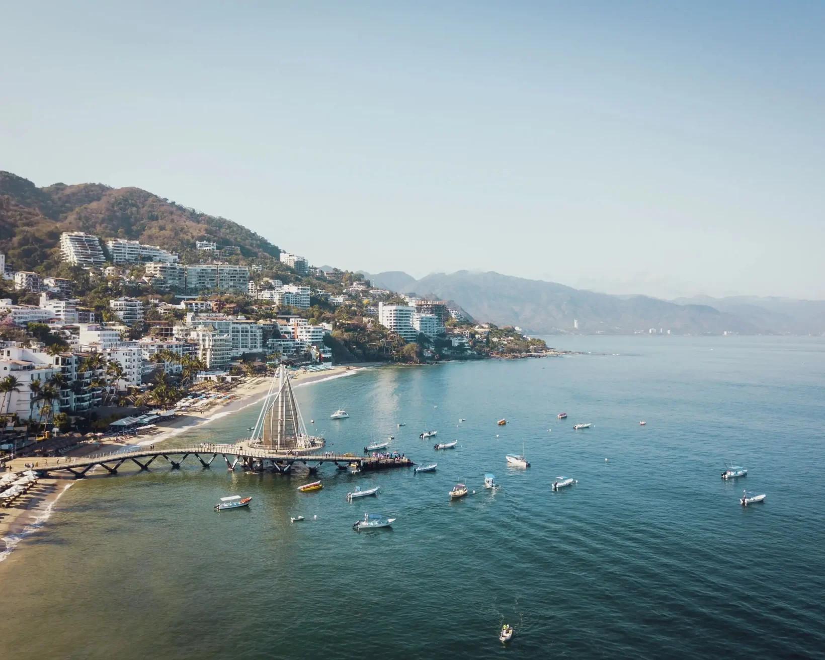 Puerto Vallarta cityscape with pier and colorful boats