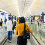Busy airport terminal with travelers, illustrating declining airline etiquette and 'naughty traveler' behaviors.