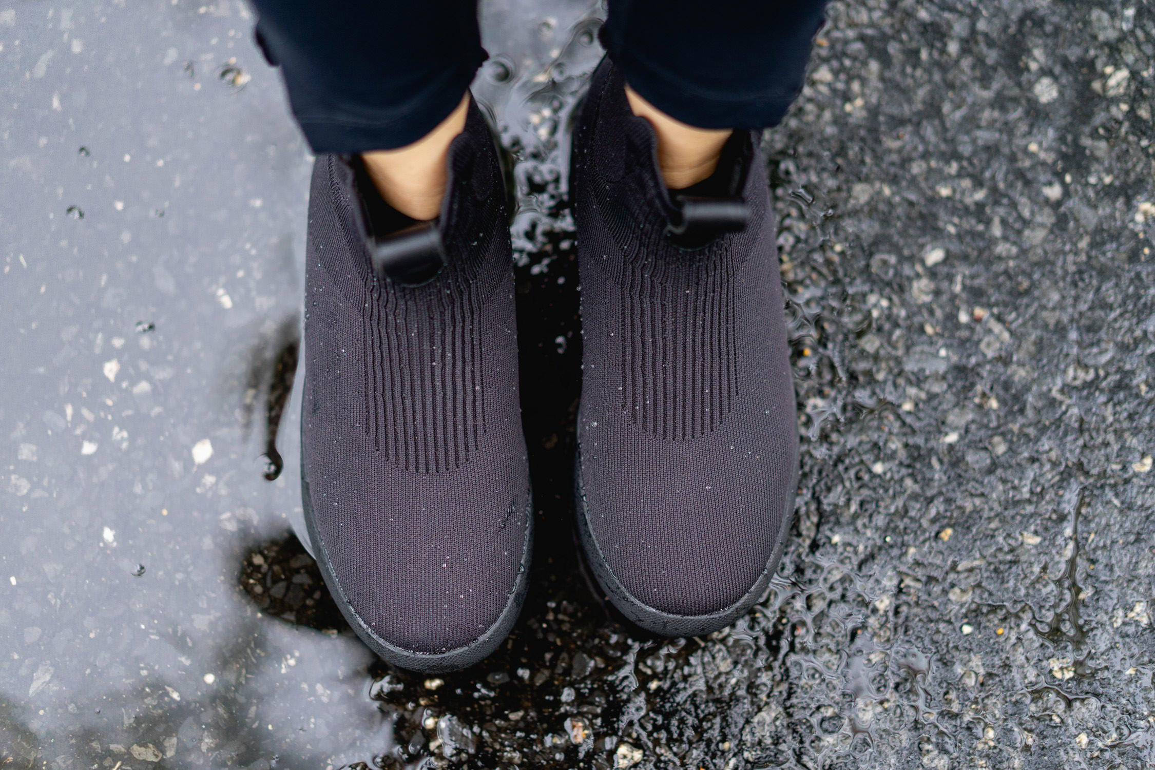 Woman wearing Vessi Weekend Chelsea boots and a dress, posing outdoors.