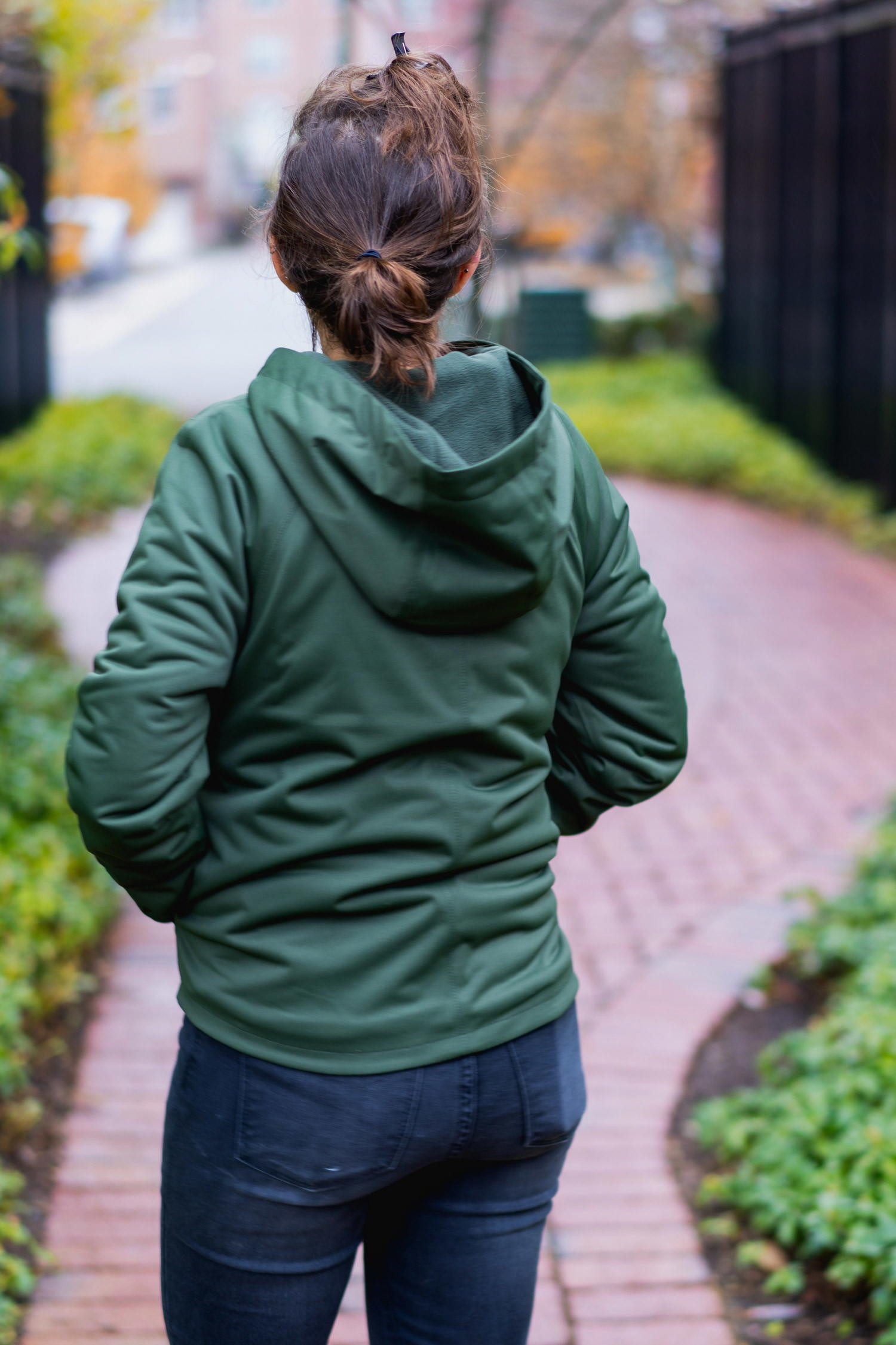 Close-up of Vessi Overcast rain jacket and Shoreline Belt Bag, highlighting the waterproof material and design.