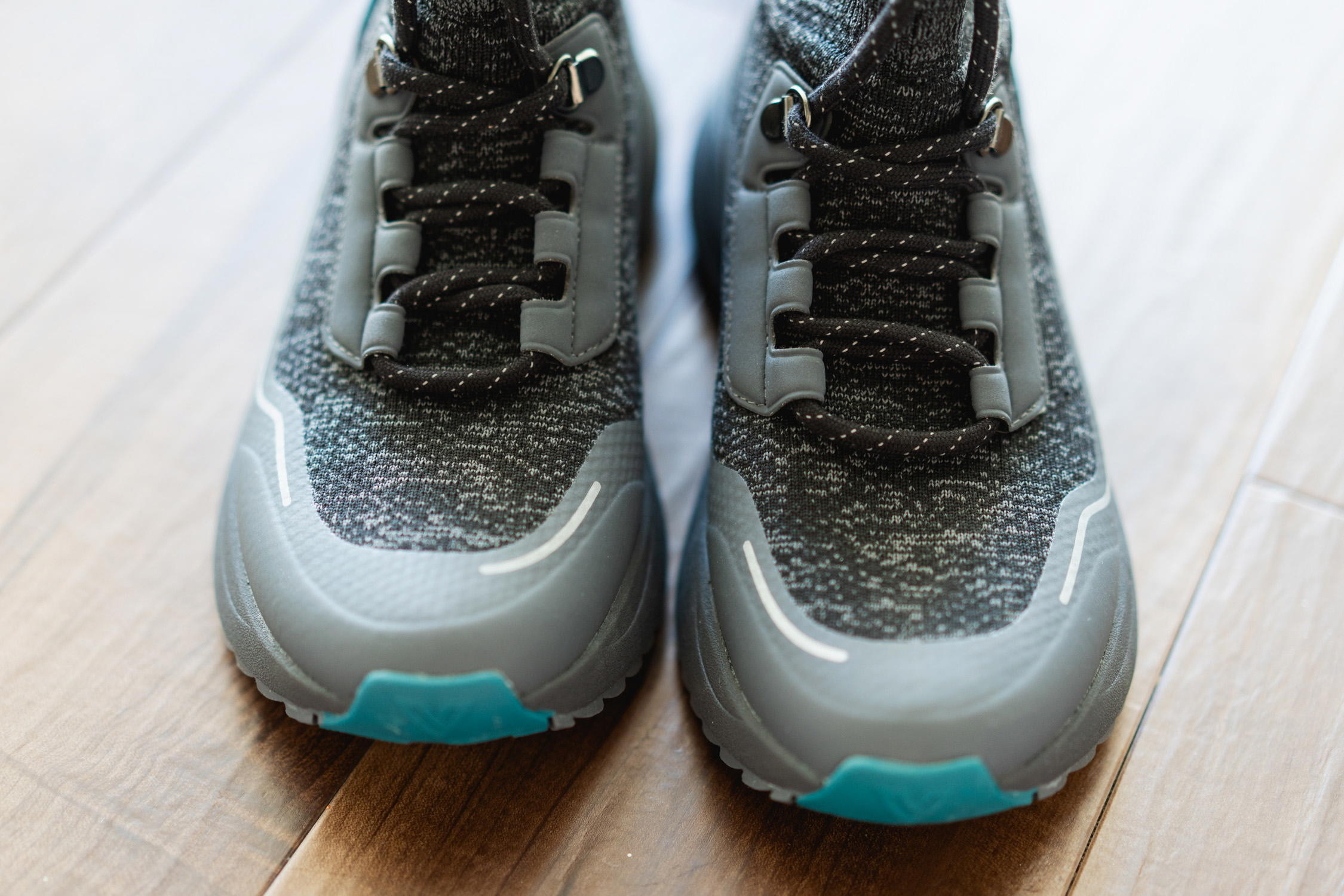 Close-up of Vessi Stormburst hiking shoes on a rocky trail, highlighting the sole and support features.