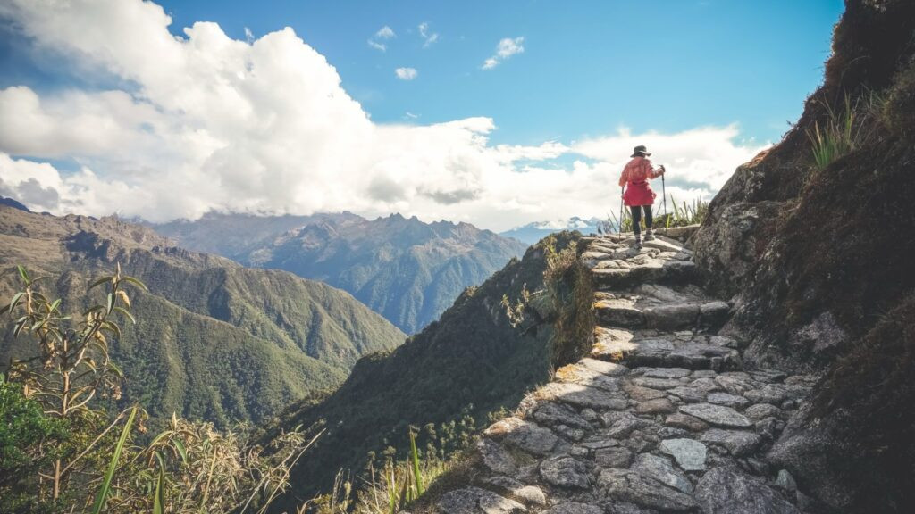 A solo tour traveler on a Wild Frontiers tour, hiking the iconic Inca Trail to Machu Picchu in Peru, showcasing adventure and exploration.