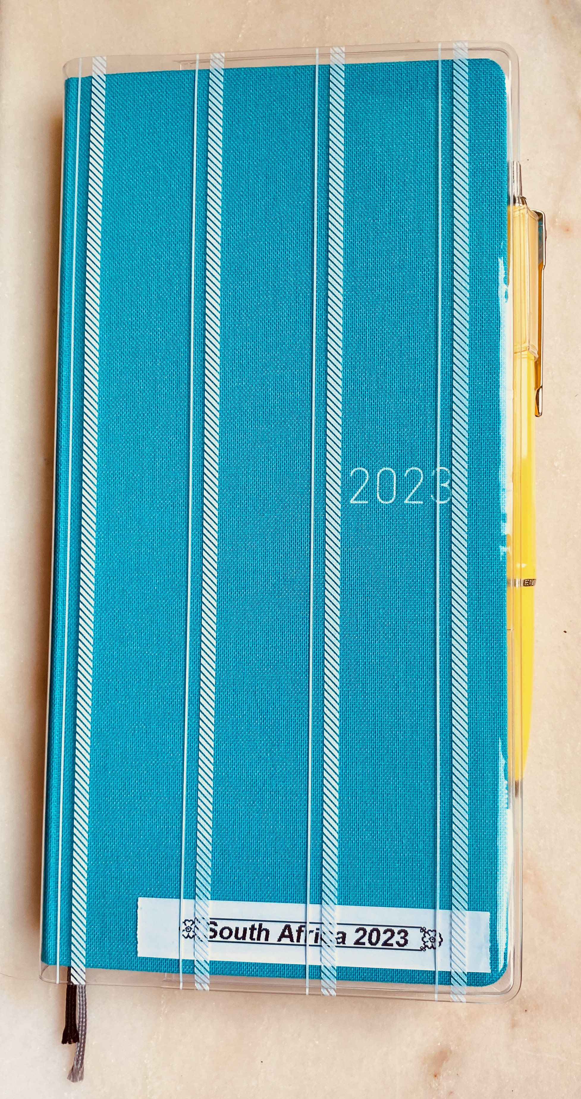 Open Hobonichi Weeks Mega planner showing receipts and paper clippings attached to pages, demonstrating its use as a travel journal and memory keeper.