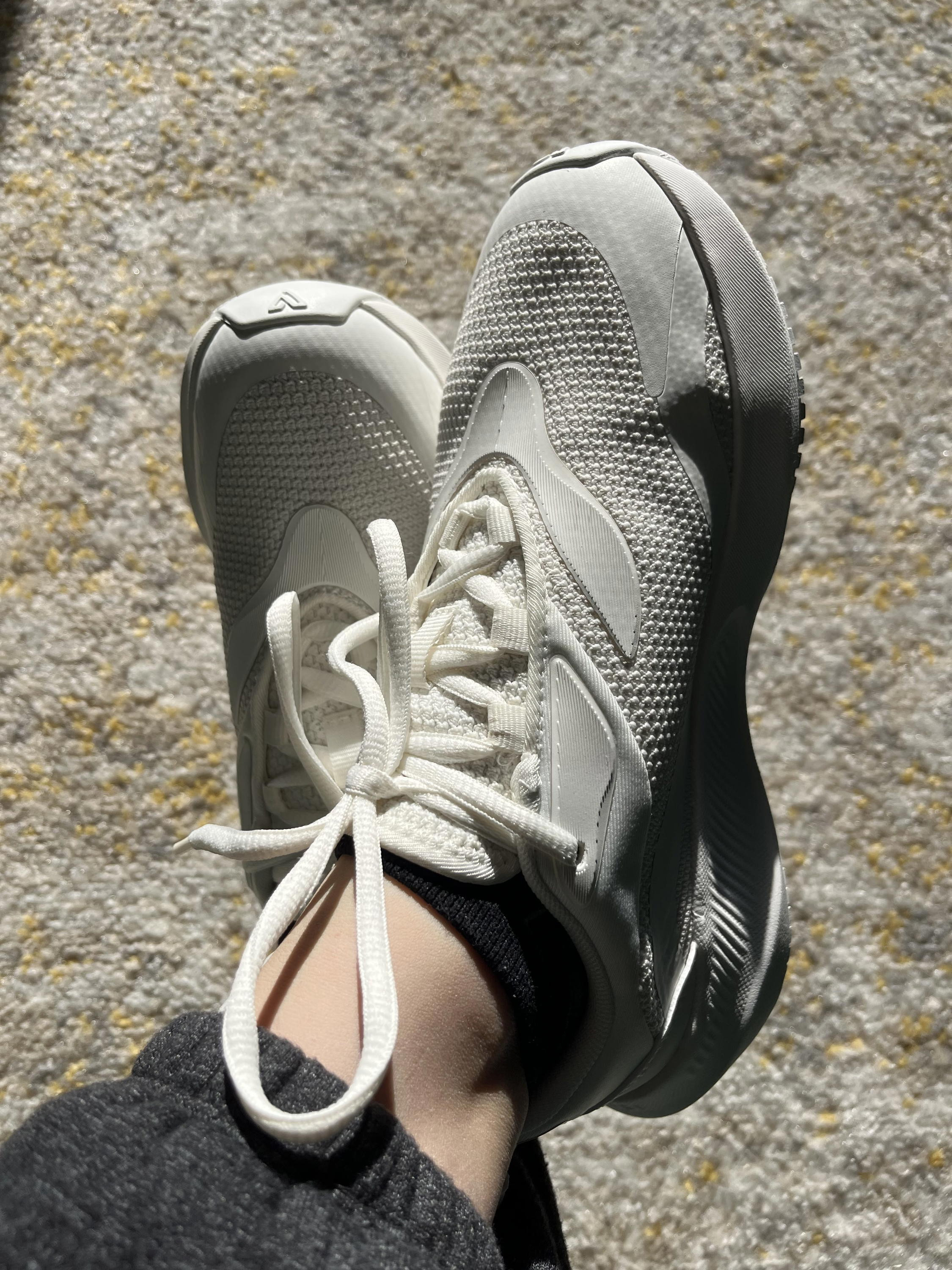Woman wearing Vessi Tidal sneakers, posing in an urban setting.