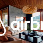 Person using Airbnb on a laptop to search for travel nurse housing