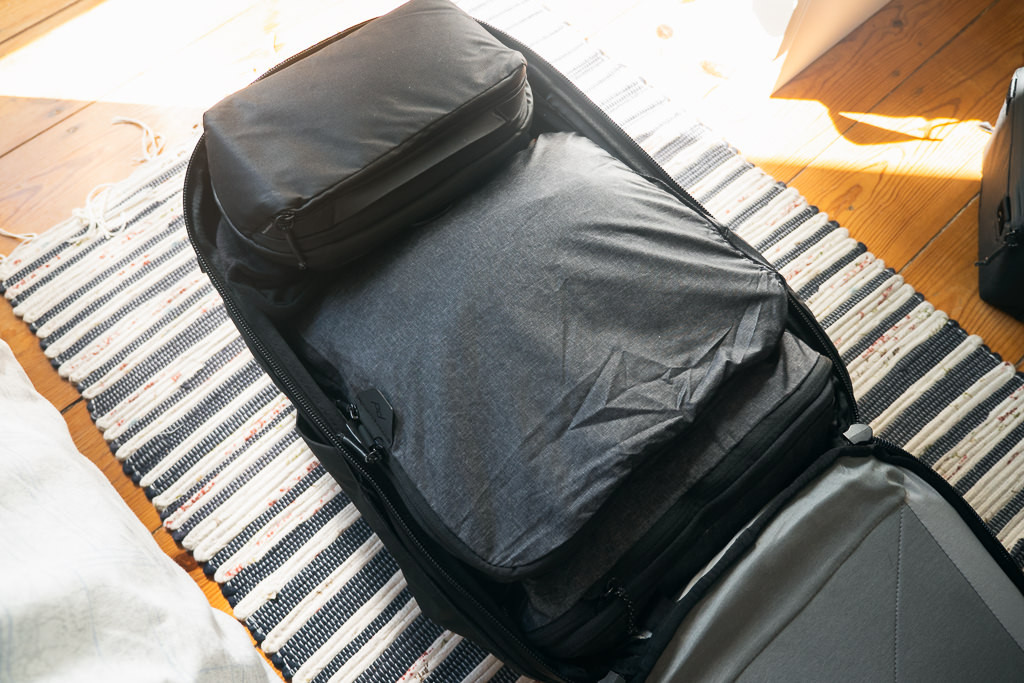 Open Peak Design large packing cube and wash pouch, displaying the internal organization and lightweight materials of these travel accessories.