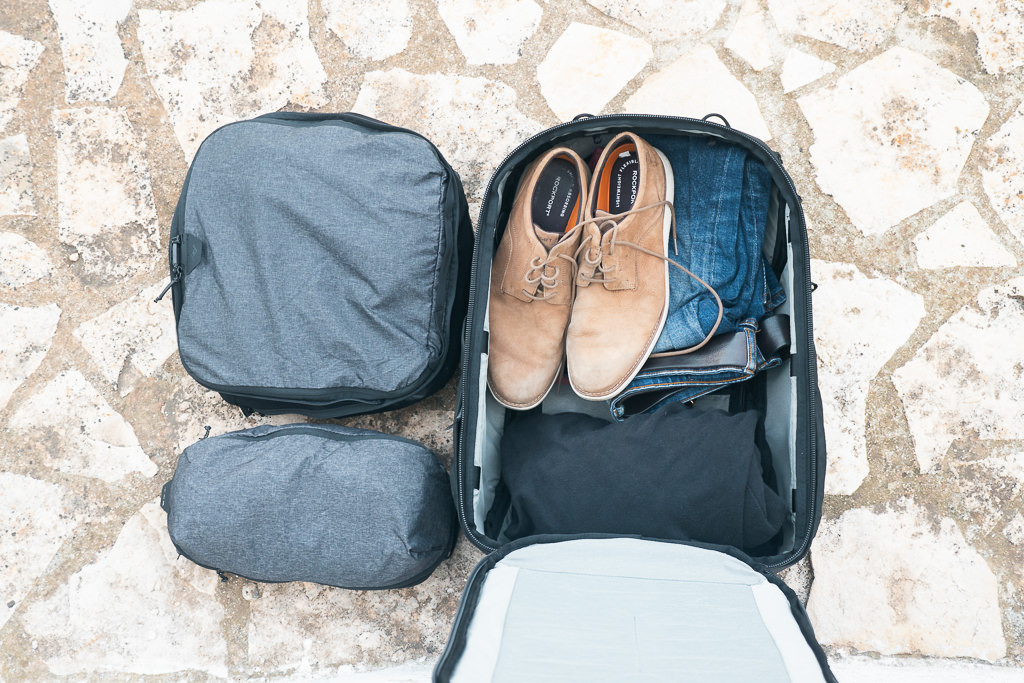Interior view of the Peak Design 45L Travel Backpack packed with accessories, demonstrating how the modular system maximizes space and organization.