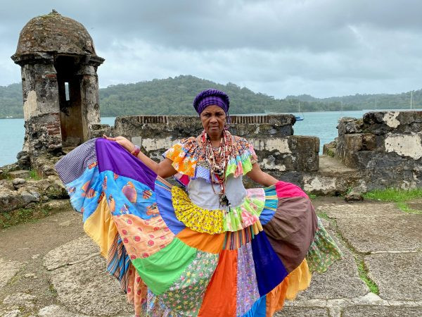 Mama Ari in traditional Congo skirt leading a cultural tour in Portobelo, Panama
