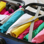 clothes rolled tightly in a carry on suitcase to save space