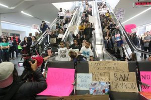 Protest at San Francisco Airport against the Muslim travel ban in 2017, with demonstrators holding signs.