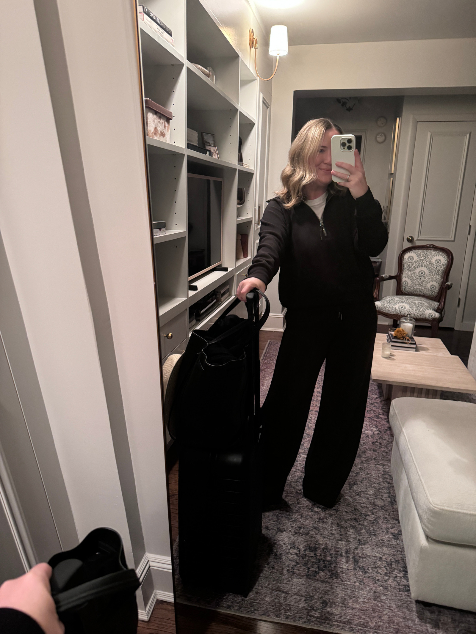 Woman in satin trousers as part of an airplane outfit, showcasing satin pants as a comfortable yet dressier travel option.