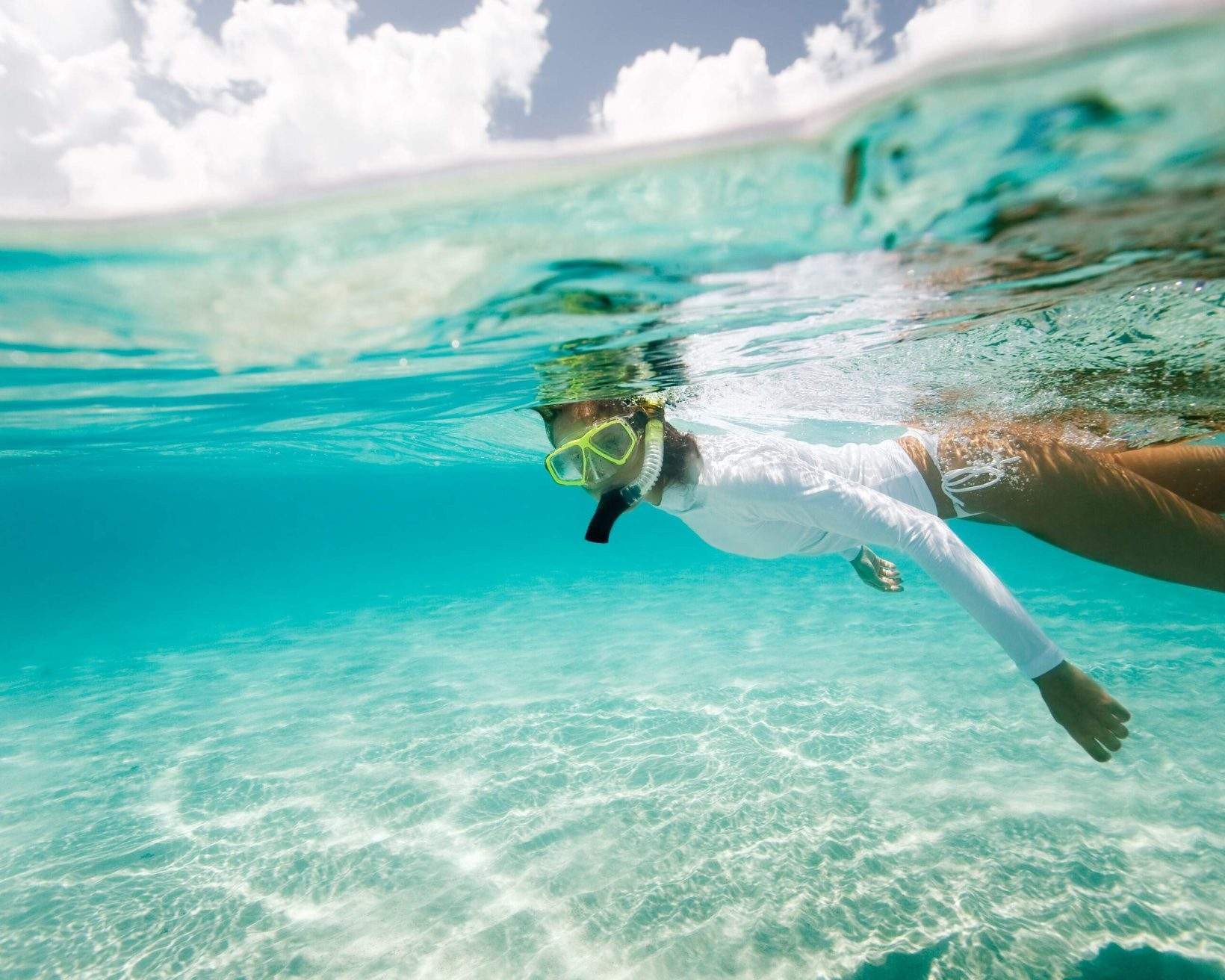 Woman snorkeling in crystal clear waters of Curaçao