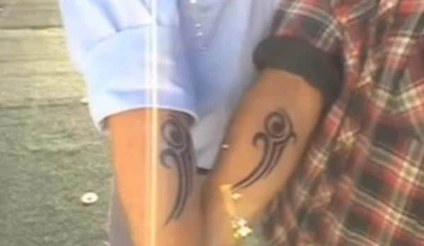 Photo of two hands with identical tattoos, part of a time traveler's claim