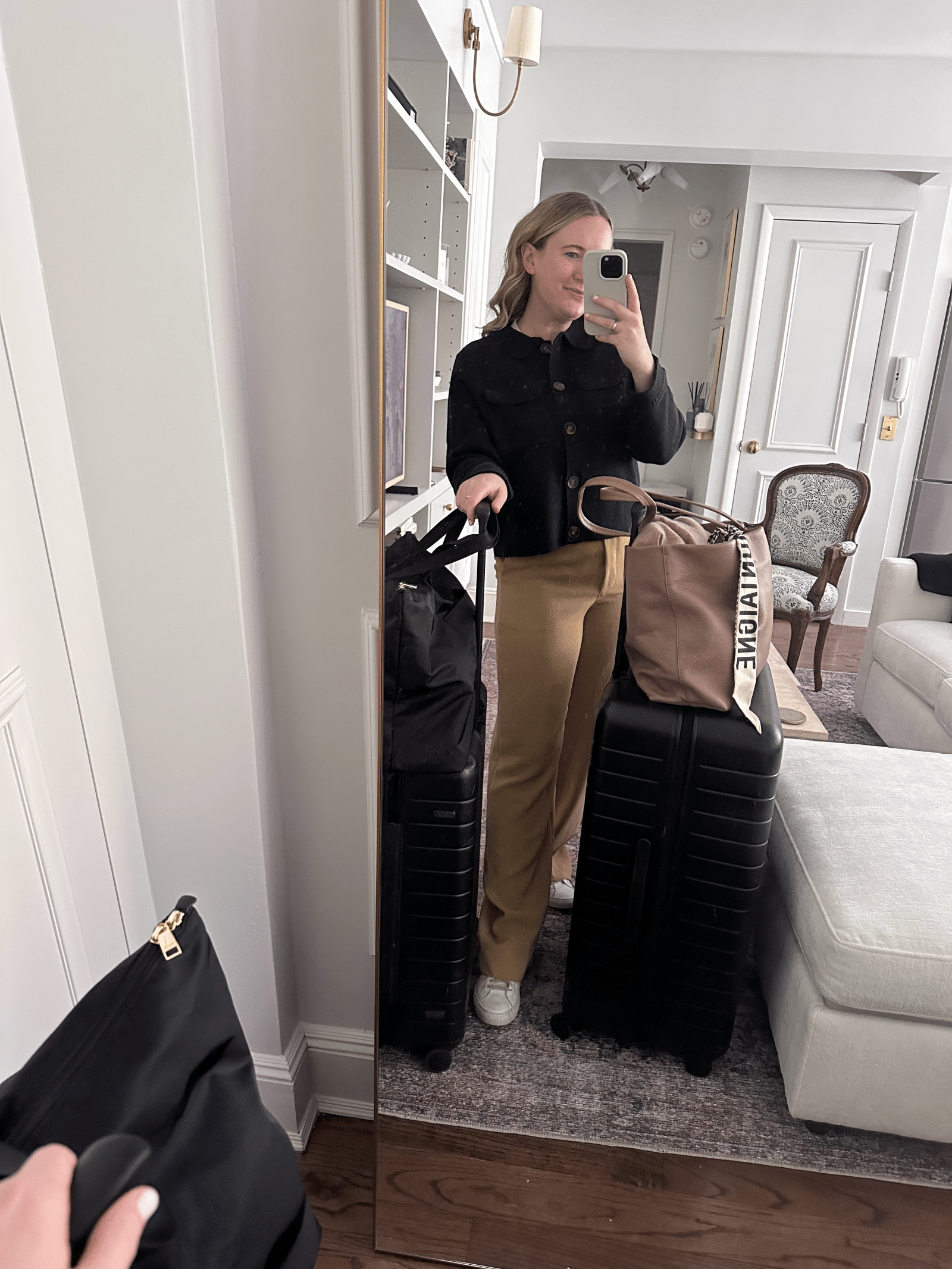 Woman in comfortable yet stylish travel attire, featuring a cozy sweater and trousers, perfect for long flights.