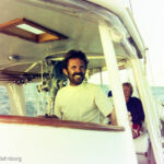 Vintage photo of Firebird travel: A father and daughter sailing on the Pacific Ocean in December 1975, embarking on a global adventure.