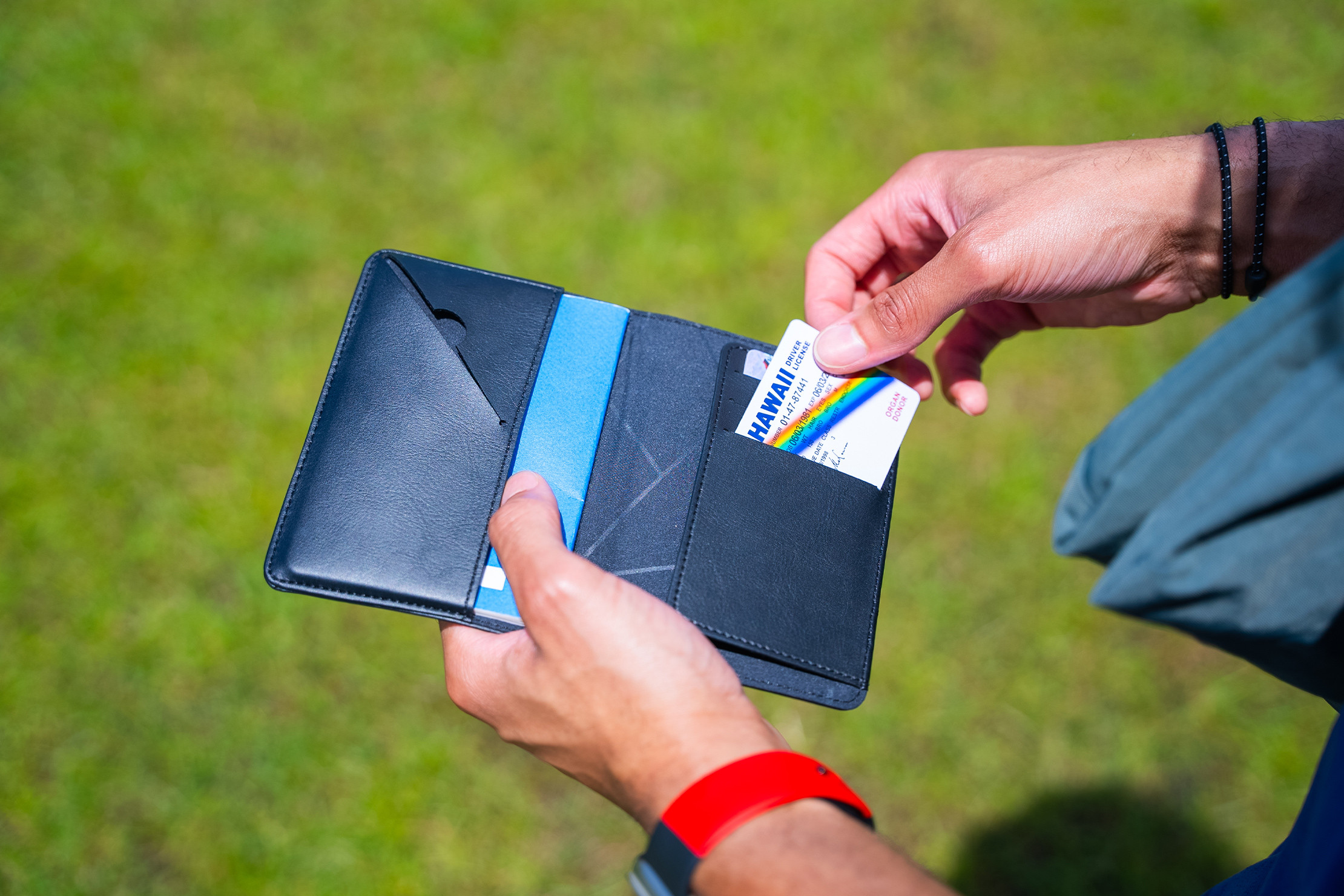 Minaal RFID Travel Wallet In-Use for Men:  Demonstrating its quick-release flap for easy passport access, a key feature for efficient male travelers.