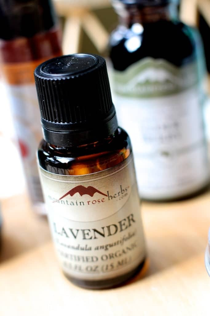 Lavender essential oil in a small purple glass bottle