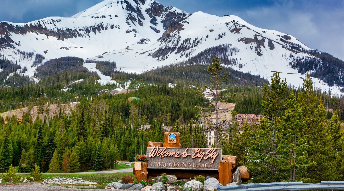 Big Sky, Montana sign in a snowy landscape, indicating a winter destination.