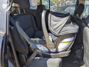 Britax Willow and Aspen base installed with the vehicle seat belt, demonstrating a secure rear-facing setup in a vehicle using the vehicle's seat belt system.