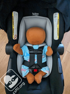 Britax Willow with newborn doll and infant insert, illustrating the comfortable and secure fit for a 7-pound newborn with the insert in use.