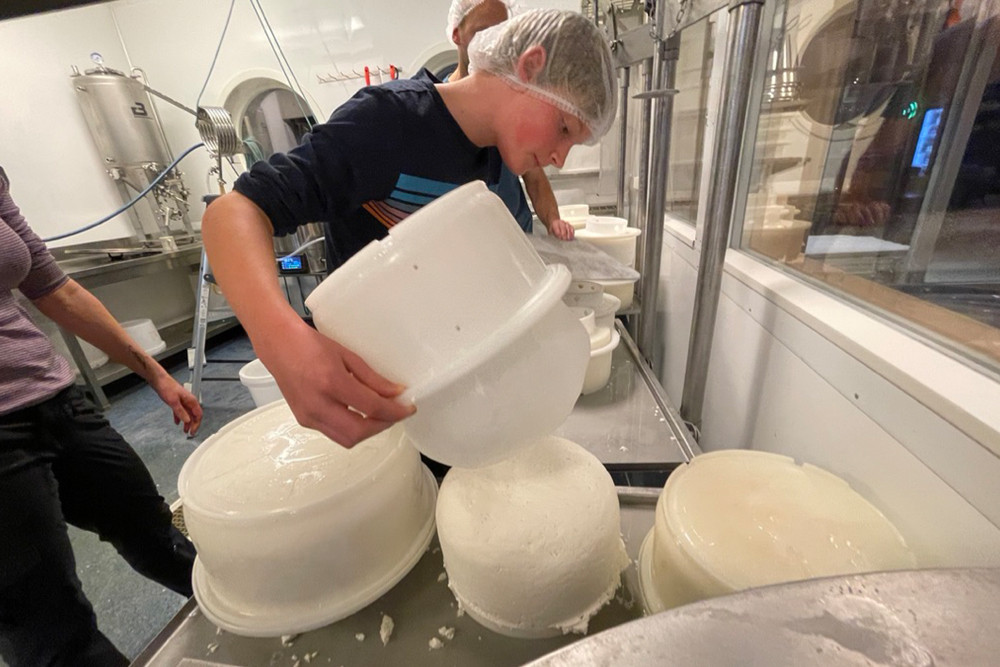 Brook’s son Zeke flipping over a fresh cheese round.