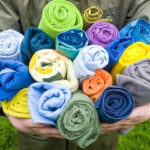 Selection of different types of travel towels being tested for absorbency, drying time, and packability.