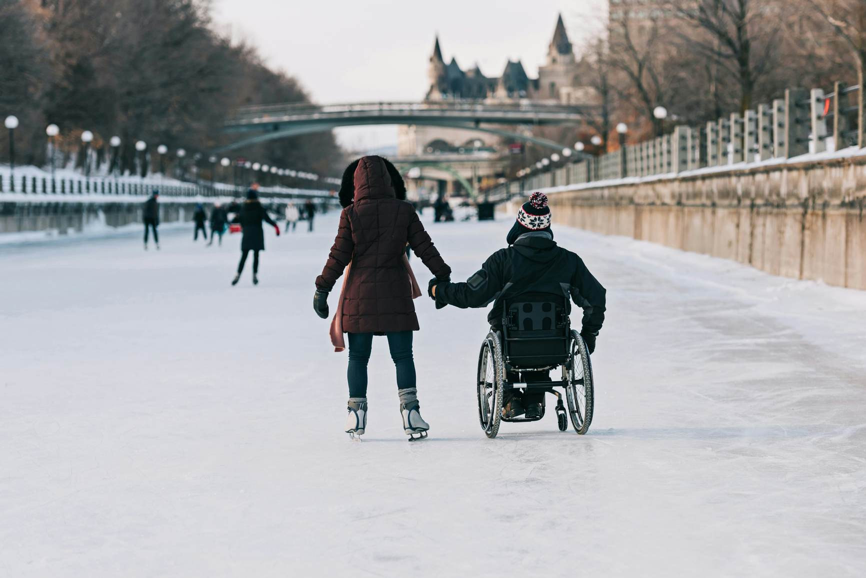 Two people ice skating on the frozen Rideau Canal in Ottawa, highlighting winter activities in Canada