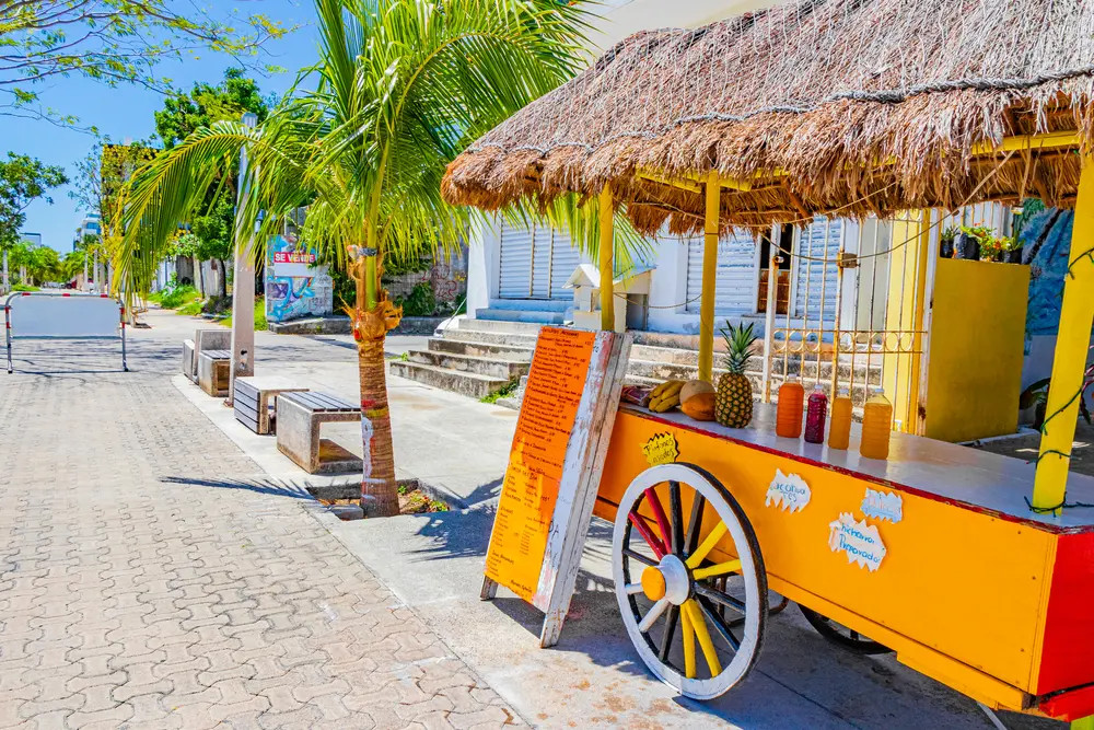 Orange juice shop on wheels in Playa del Carmen Mexico, showcasing accessible street life for all clear travel in Cancun.