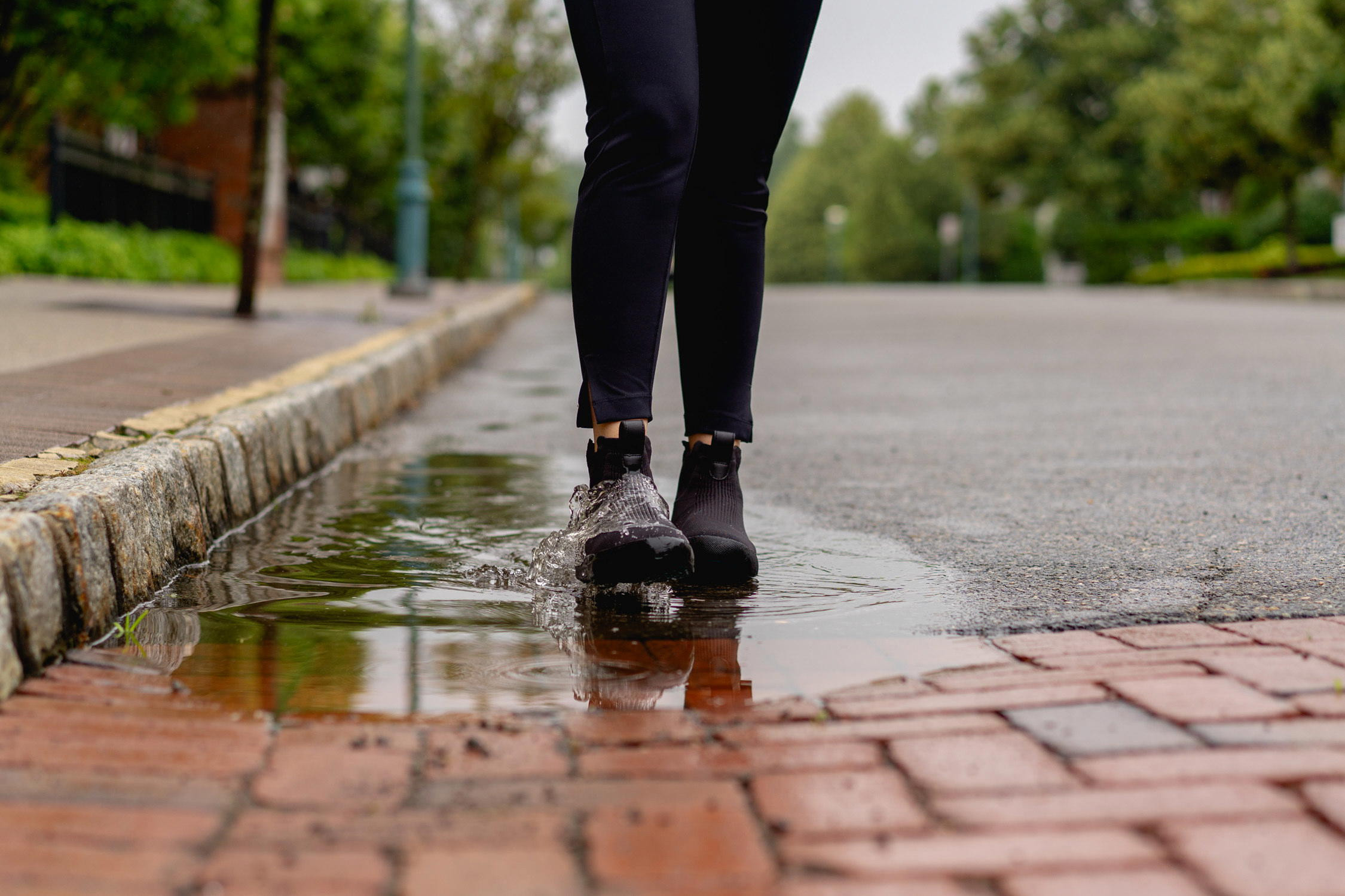 Stepping into a puddle wearing Vessi Weekend Sneakers.