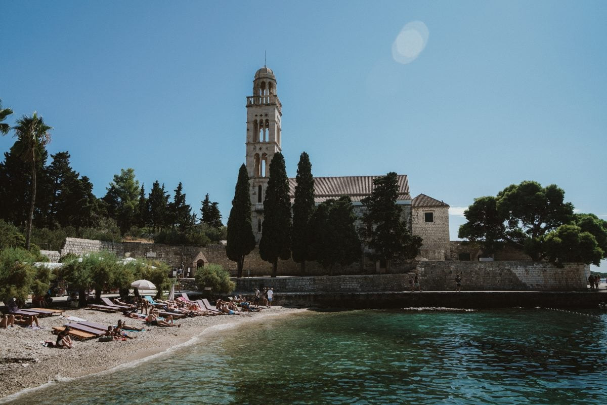 Unwinding and enjoying the tranquil beaches of Hvar Island, a perfect day of relaxation within your Croatia travel plan.
