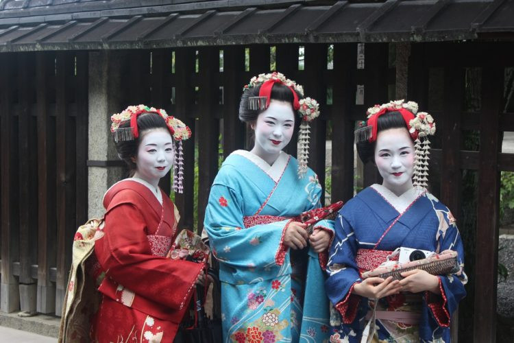 A Geisha walking in Gion district, Kyoto, in traditional attire.