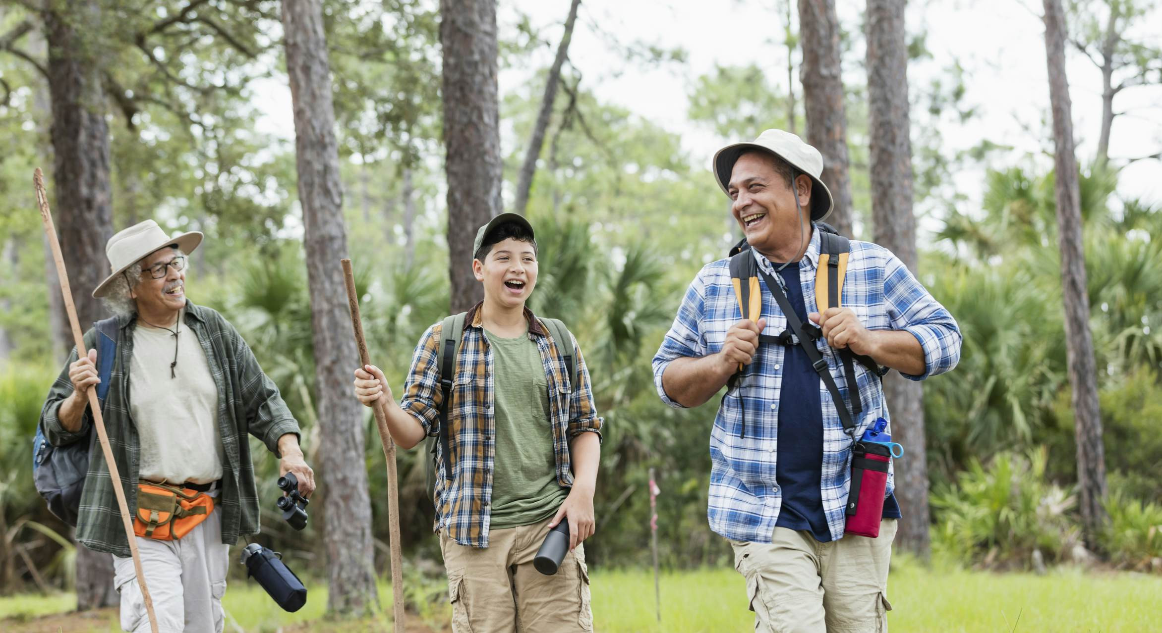 A multi-generational Hispanic family hikes in a Florida park