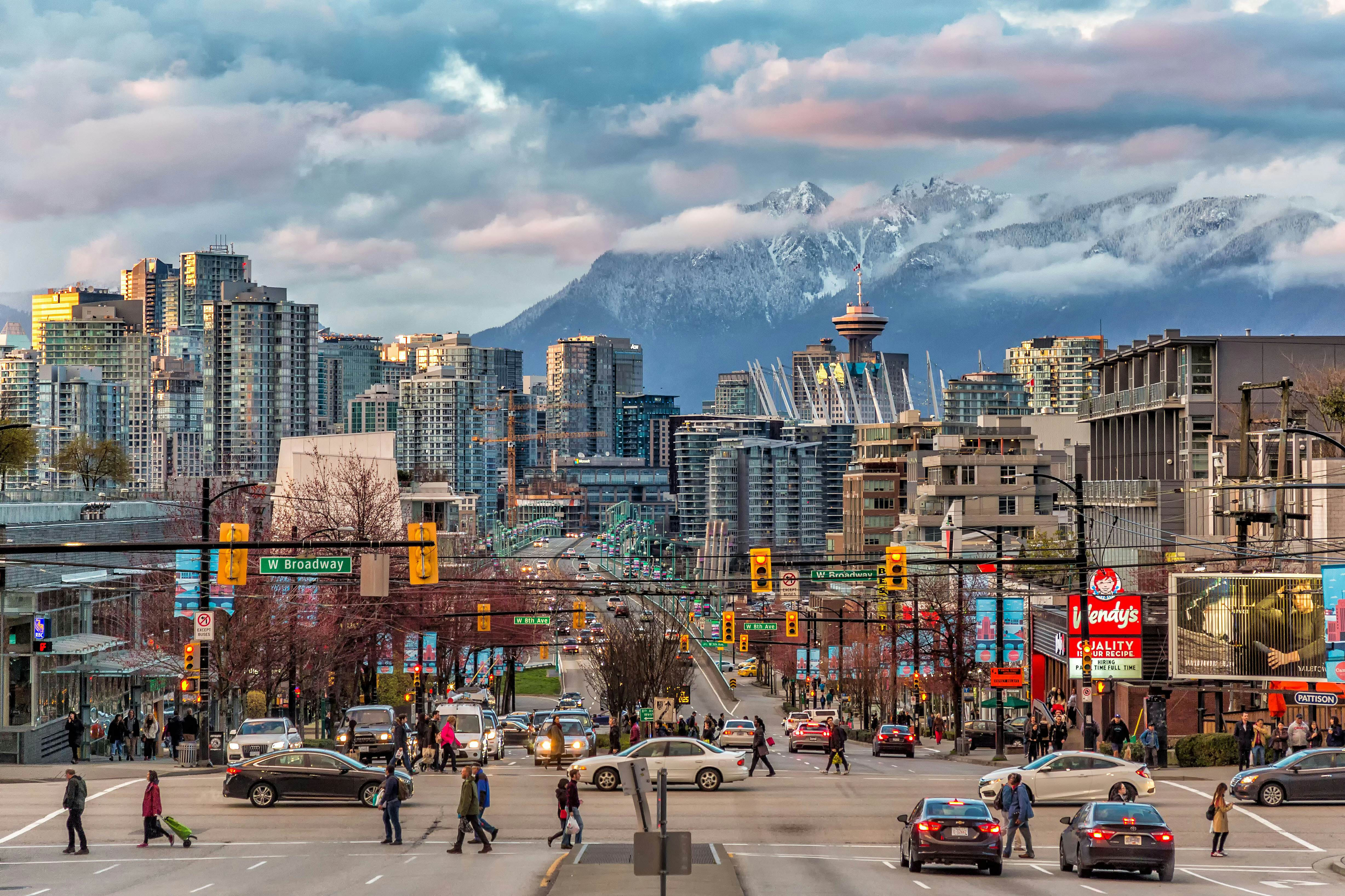 Vancouver downtown skyline with snow-capped mountains in the background, showcasing the city's natural setting
