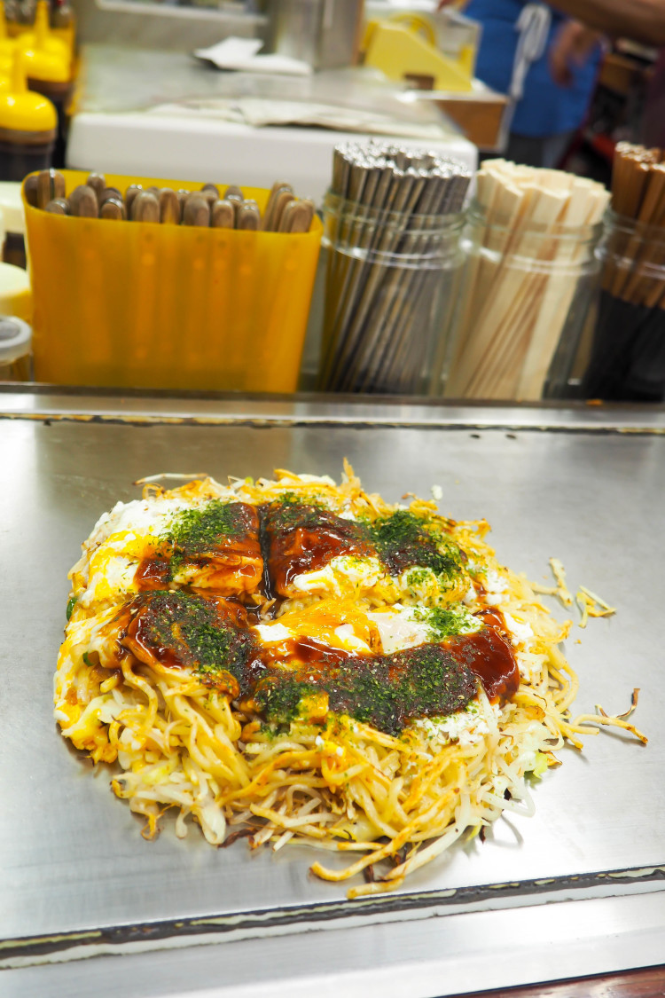 Okonomiyaki being cooked at Okonomimura in Hiroshima, a local specialty pancake.