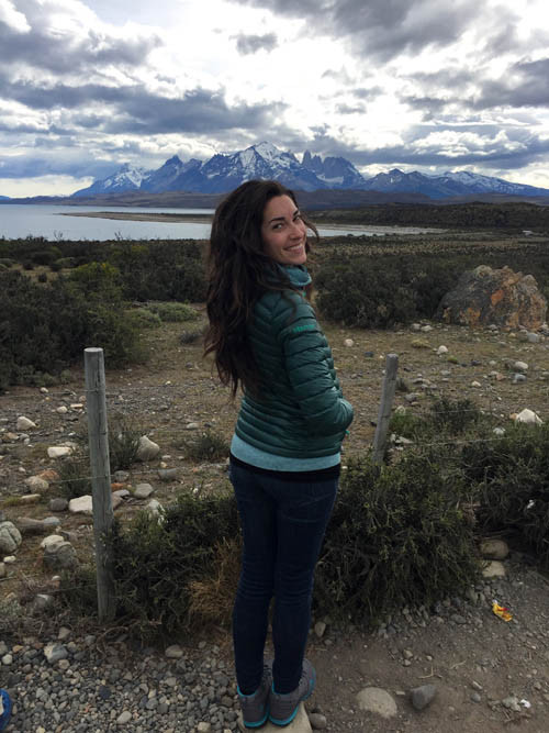 Solo female traveler looking at a sunset in Chile, embodying the feeling of finding home while traveling