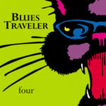 John Popper of Blues Traveler performing live, showcasing his harmonica skills and stage presence.