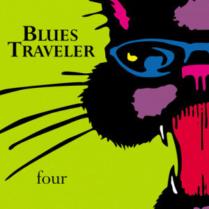 John Popper of Blues Traveler performing live, showcasing his harmonica skills and stage presence.
