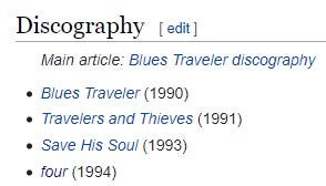 Blues Traveler in concert, with John Popper front and center playing harmonica, highlighting the band's dynamic stage presence.