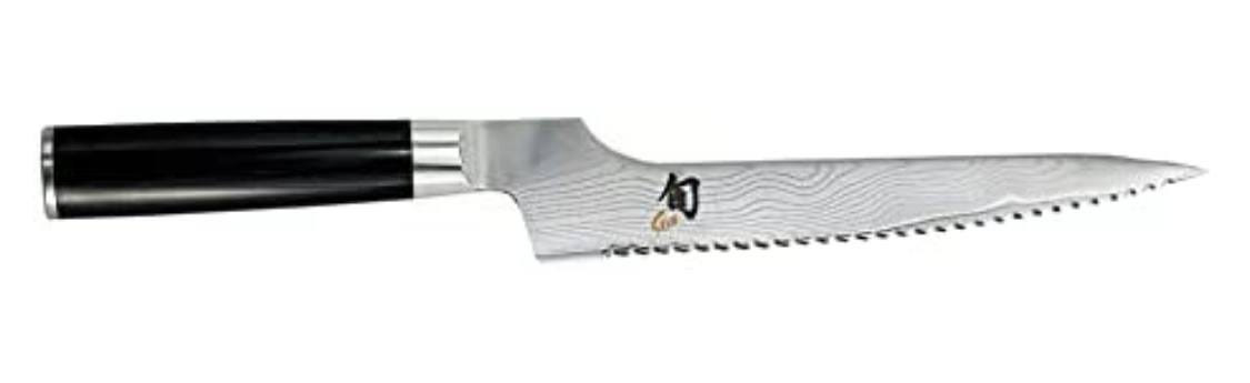 Offset serrated knife from Shun, highlighting its ergonomic design and scalloped edge for chopping chocolate.