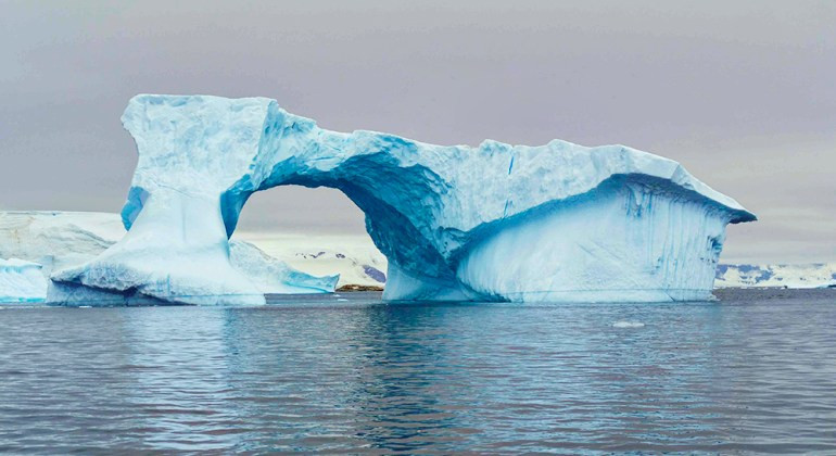 An ice bridge in Antarctica showcases the stunning glacial formations and icy landscapes explored during a wilderness travel adventure.
