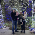 Alex and her family smiling while standing outside in a campground.