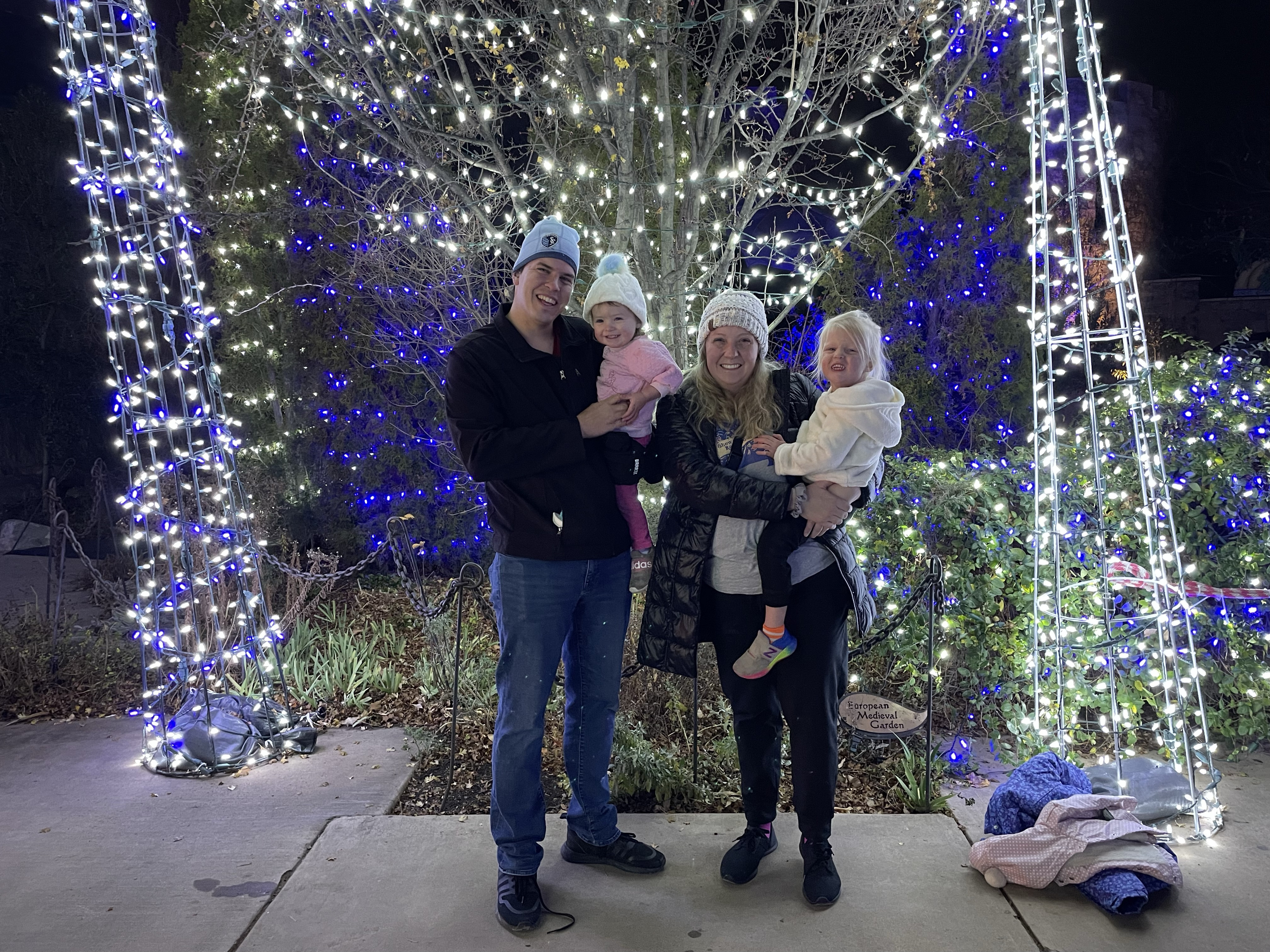 Alex and her family smiling while standing outside in a campground.
