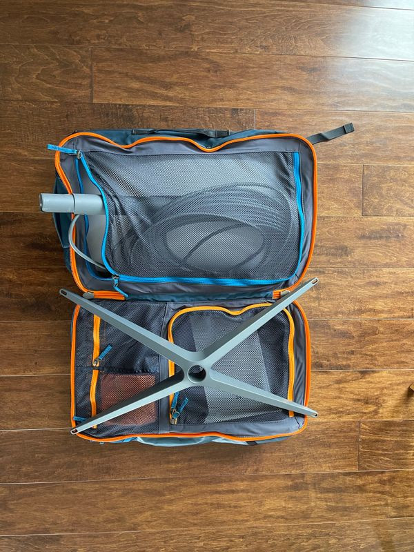 Trying to fit the Starlink Gen 2 dish and components into a travel backpack designed for clothing, highlighting the challenge of the fixed mounting pole.
