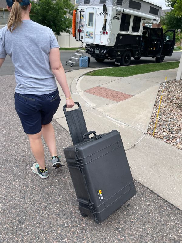 Pulling the rolling Pelican 1610 case, showcasing its portability and ease of transport for Starlink equipment during overland travel.
