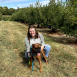 Emily Cormier, a pediatric travel physical therapist, smiling outdoors.