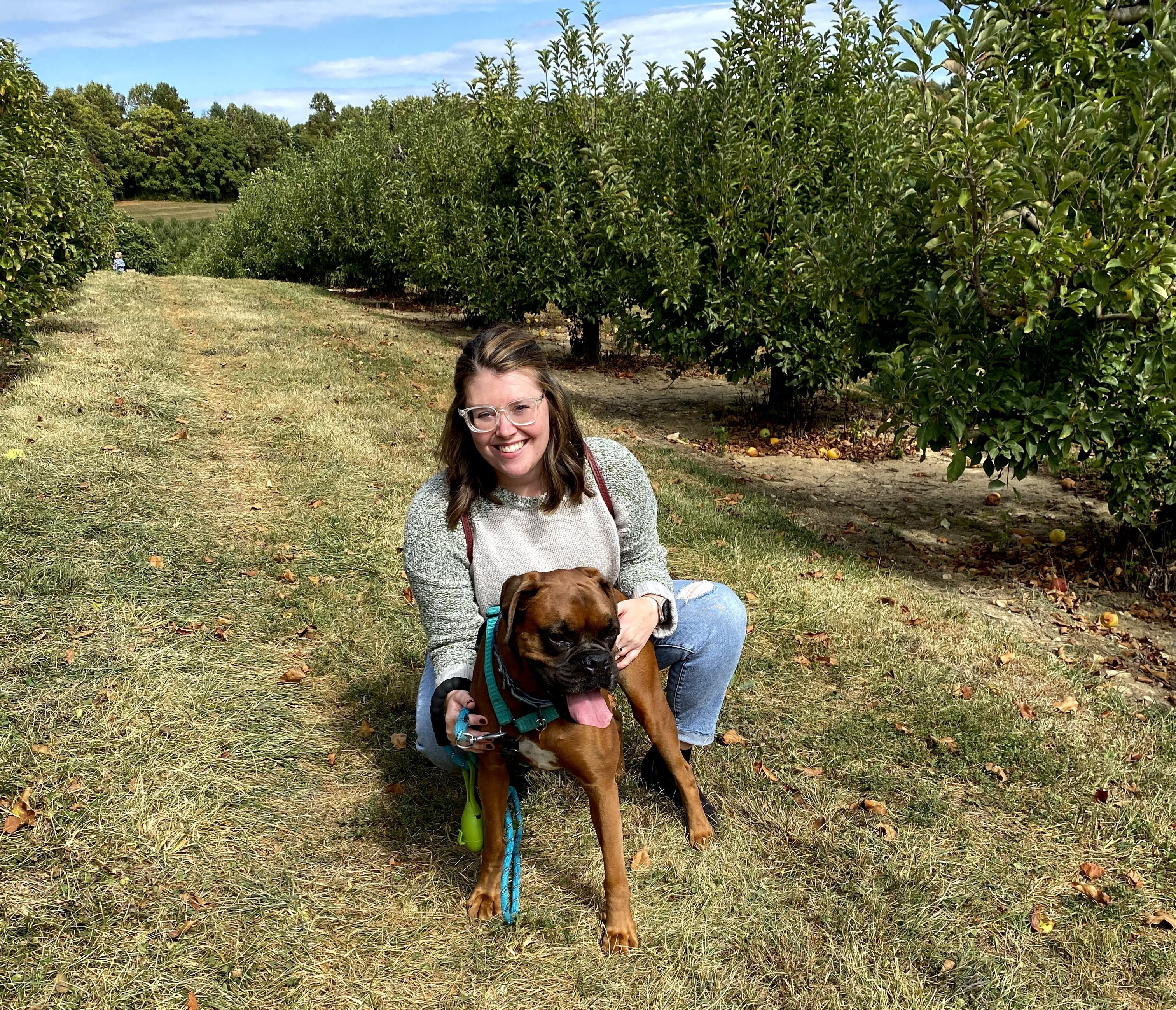 Emily Cormier, a pediatric travel physical therapist, smiling outdoors.