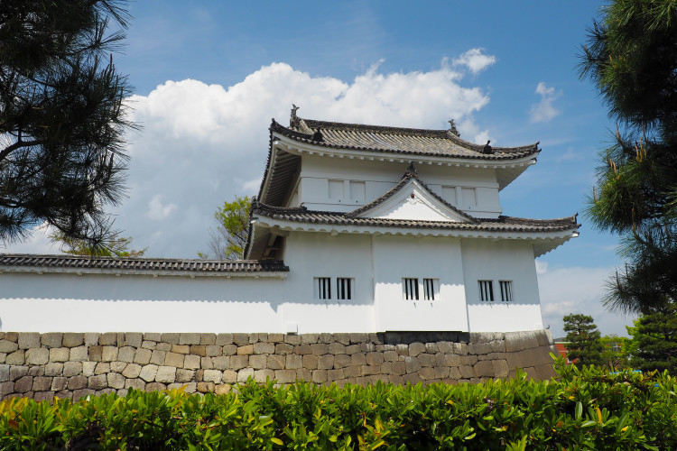 Gardens and stone walls at Nijo Castle, Kyoto, showcasing Japanese landscape design.