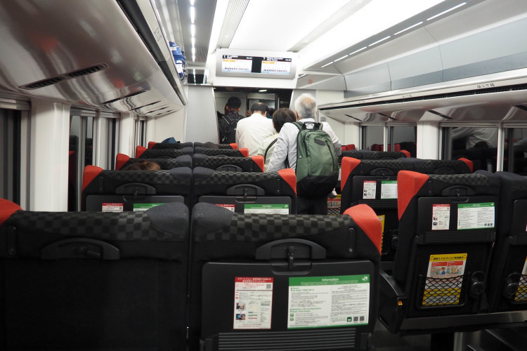 Traveler with luggage at a train station in Japan, ready to depart.