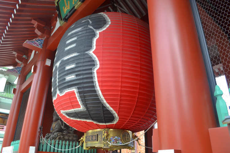 Incense burning at Sensoji Temple, with temple buildings in the background.